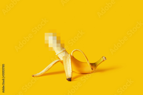 Censored peeled banana with condom photo