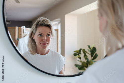 Morning Beauty Routine in front of the toilet mirror photo