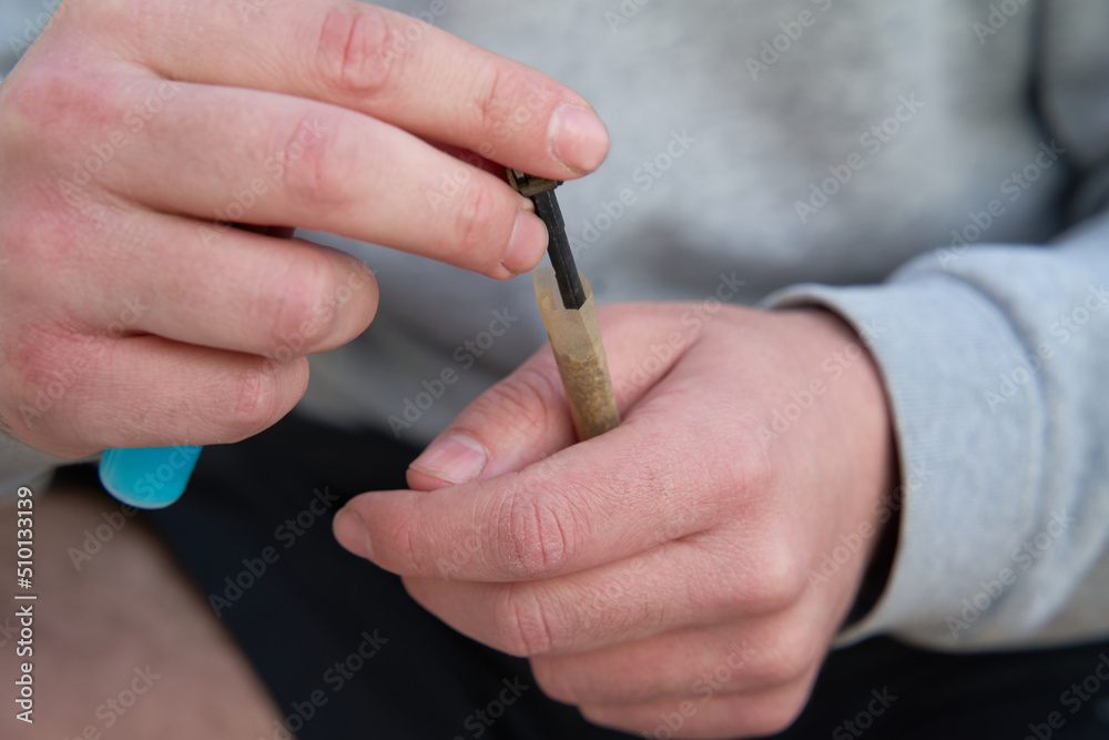 Man rolling cannabis spliff