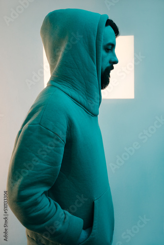 Portrait of a man with a beard in a green hood photo