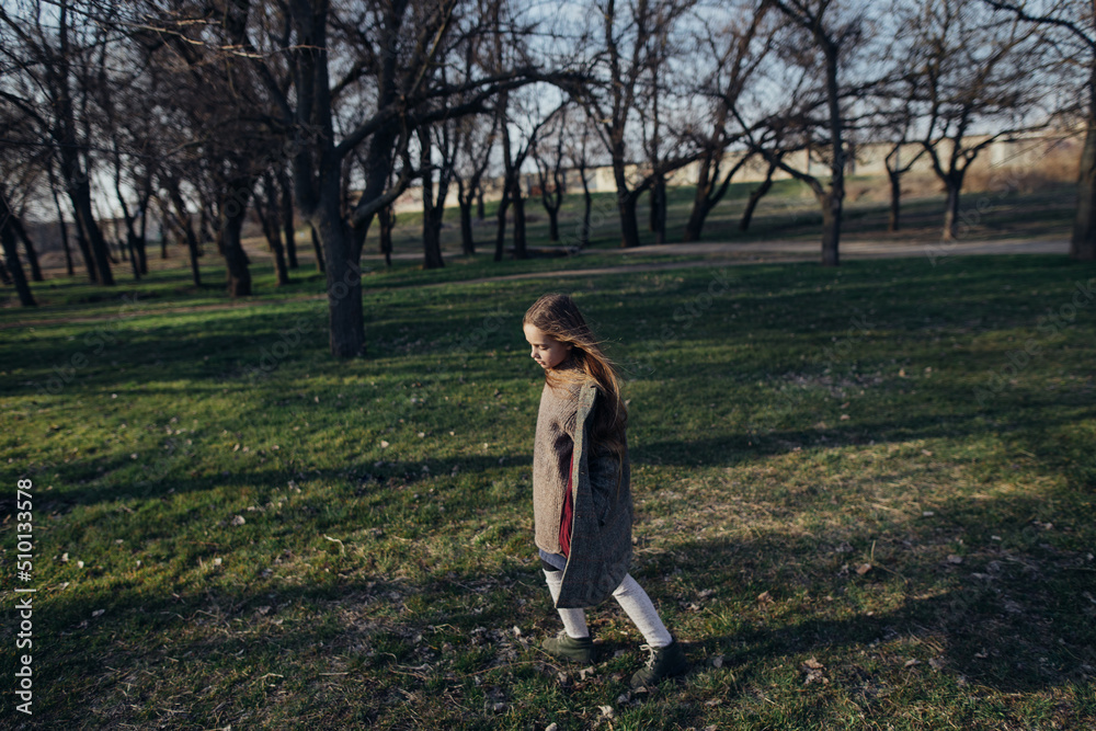 blonde girl walking in the park blonde girl walking in the park