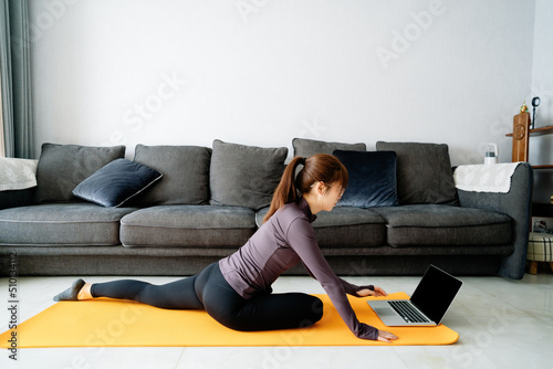 Young Asian girl doing yoga at home photo