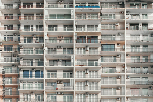 Light white building with a lot of balconies