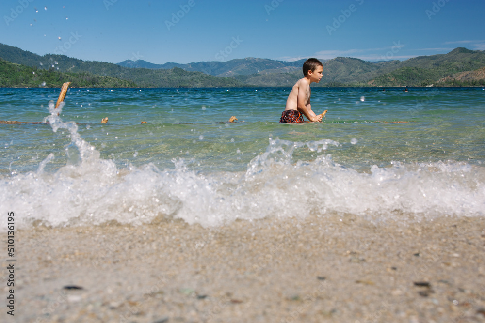Child Playing in Lake During Summertime in California Child Playing in Lake During Summertime in California