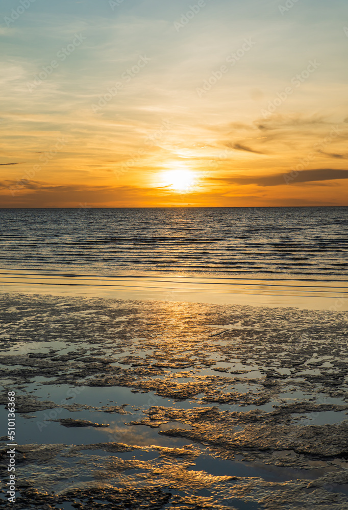 Sunset sky clouds vertical over sea in the evening with colorful orange sunlight reflect on the sea landscape with summer travel concept