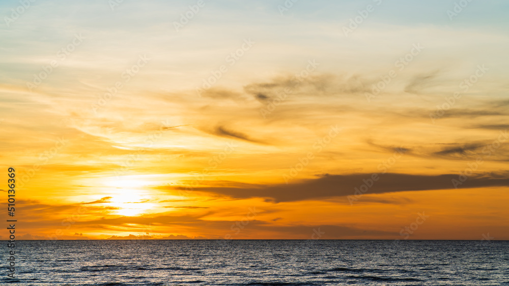 Sunset sky over sea in the evening with orange sunlight, landscape in summer season on seaside beach
