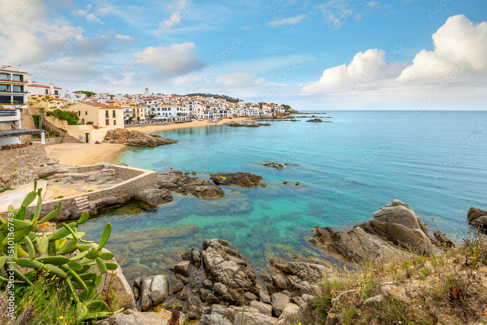 The rocky coast, sandy beach and whitewashed village at the fishing town of Calella de Palafrugell, on the Costa Brava Spanish coast.