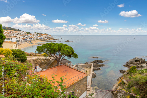 The rocky coast, sandy beach and whitewashed village at the fishing town of Calella de Palafrugell, on the Costa Brava Spanish coast. photo