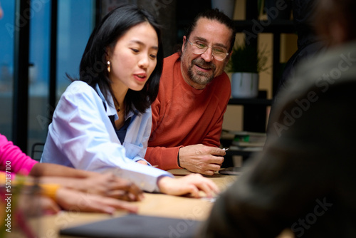 Diverse businesspeople playing card game