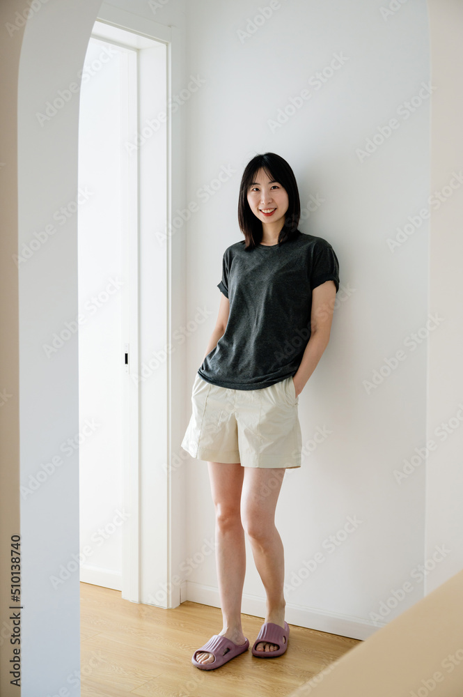 Portrait of young woman standing at home Portrait of young woman standing at home