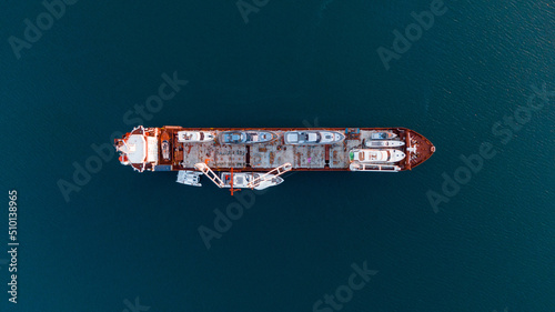 drone overhead view of a Cargo ship transporting yachts onboard photo
