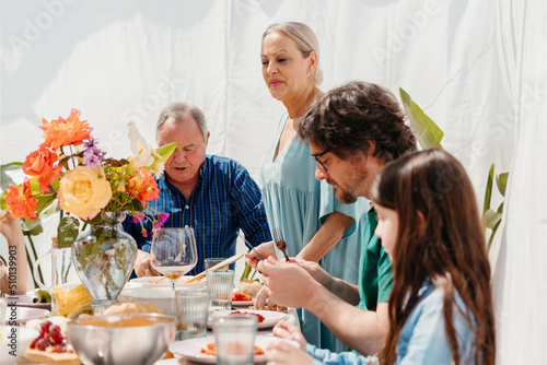 Family enjoying a delicious lunch during spring photo