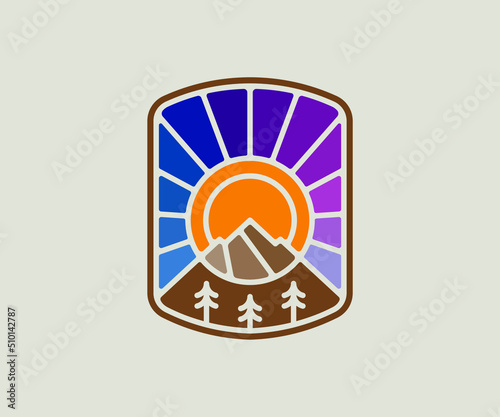 Mountain sunset emblem graphic. Stained glass style badge.