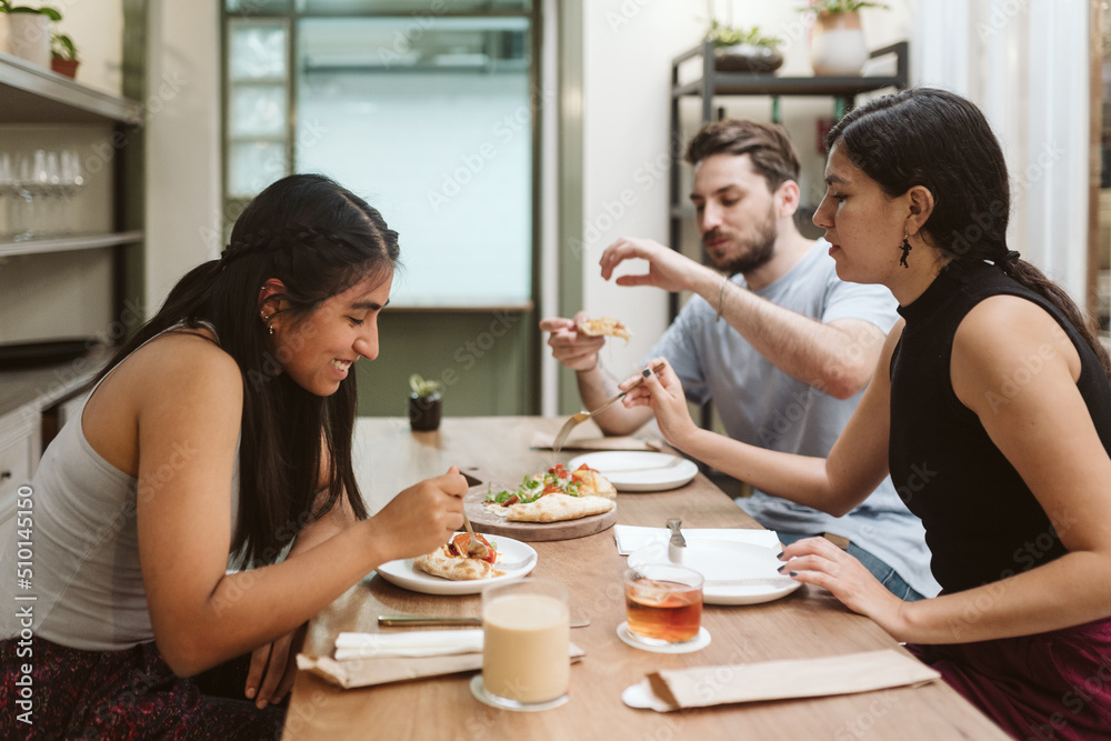 Woman laughing with her friends during lunch Woman laughing with her friends during lunch