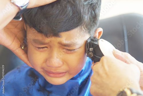 Asian boy, 4 years old, do a hair cuts and cries.       