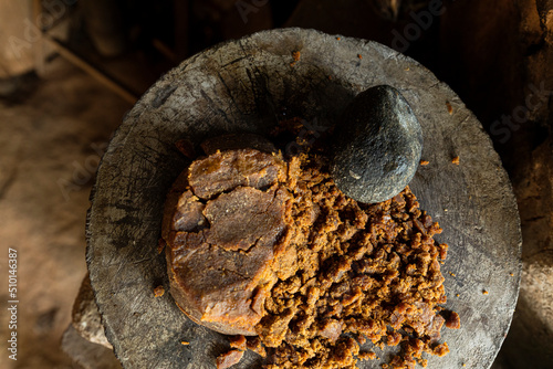 piloncillo or sugar cane ground with a stone in a traditional kitchen photo