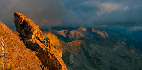 Woman climbing in breathtaking mountain landscape 