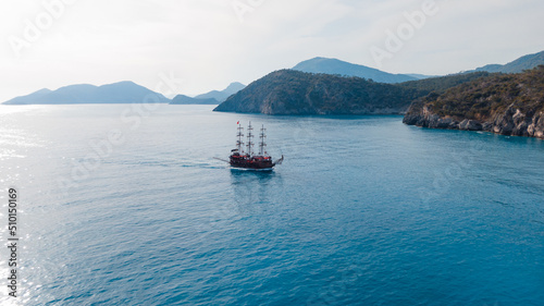 excursion vessel styled as a pirate ship passing by islands photo