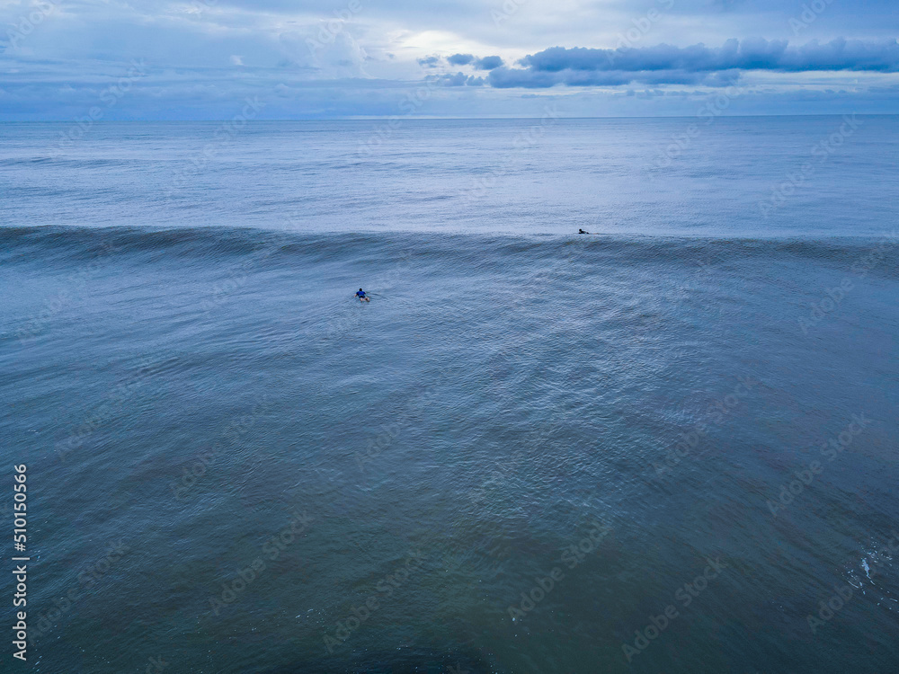 Beautiful aerial view of Surfers in Hermosa Beach - Jaco in Costa Rica Beautiful aerial view of Surfers in Hermosa Beach - Jaco in Costa Rica
