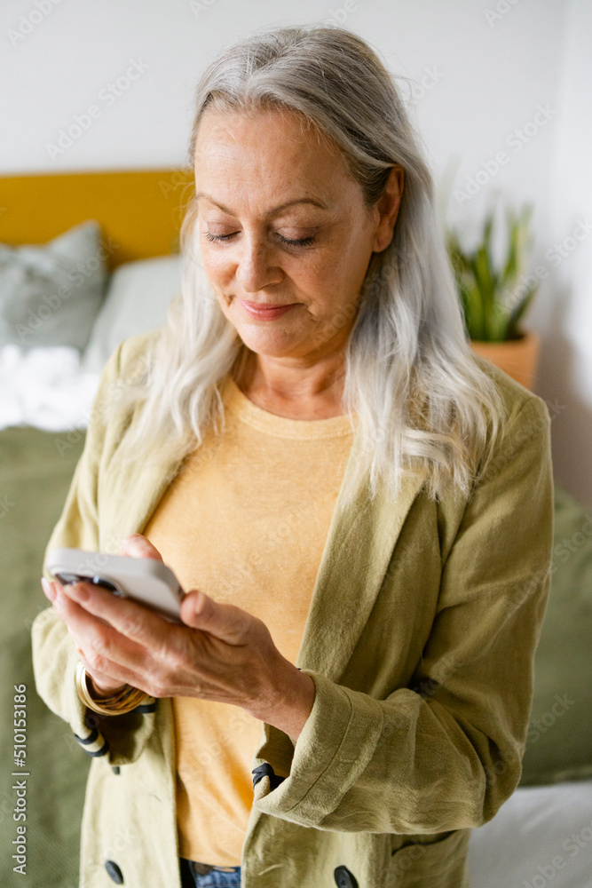 Cool senior woman watching smartphone at room Cool senior woman watching smartphone at room