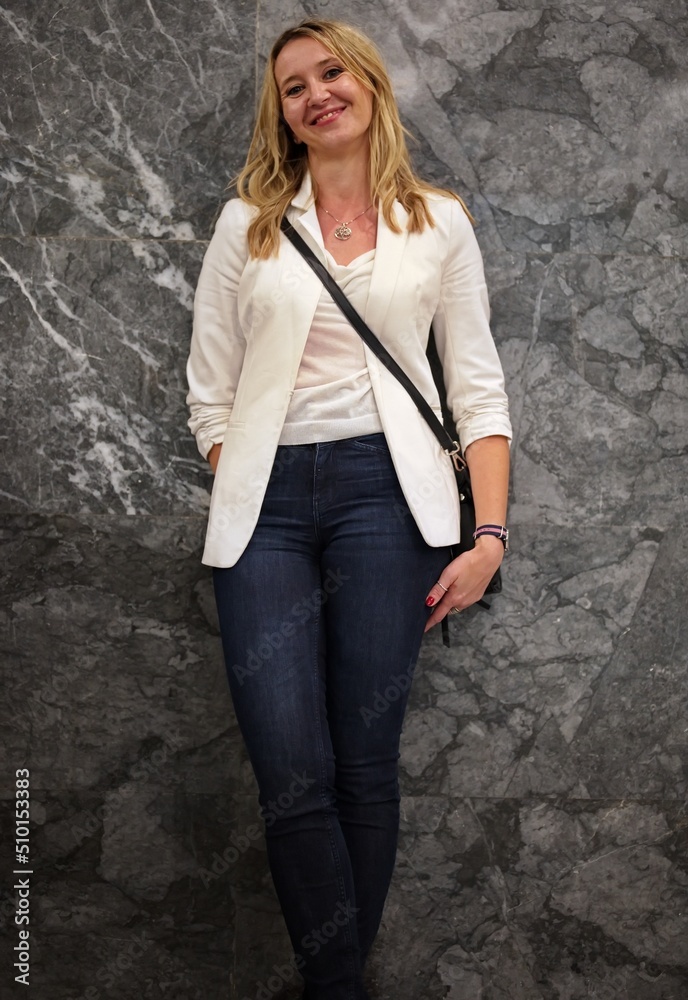 Beautiful blond mature woman standing against the wall Beautiful blond mature woman standing against the wall