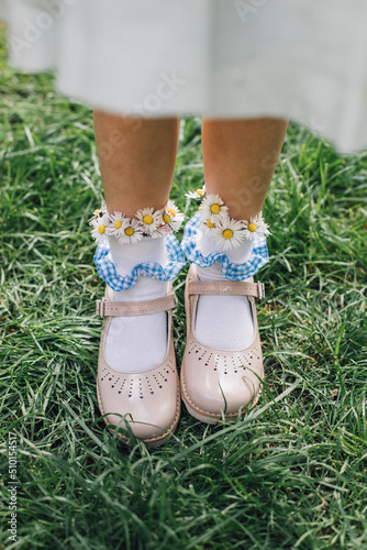 A Child Wearing Daisies in Her Socks