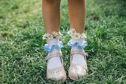 A Child Wearing Daisies in Her Socks