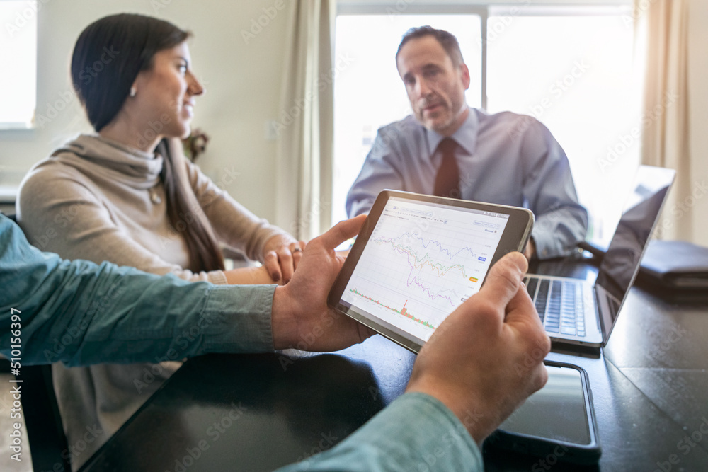 © Sean Locke/Stocksy - Male Client Looks At Financial Information On Tablet © Sean Locke/Stocksy - Male Client Looks At Financial Information On Tablet
