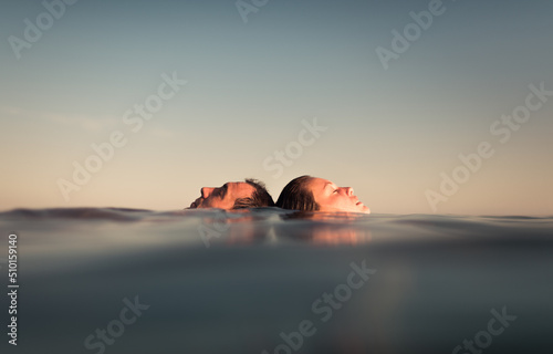 Couple floating together on sea during holidays photo