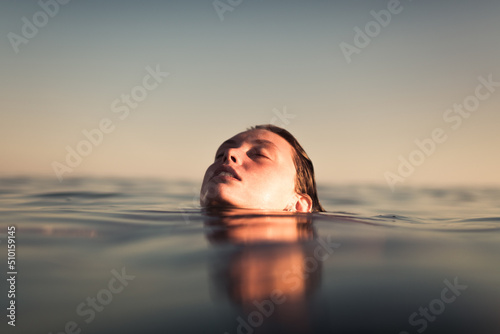 Woman enjoying a relaxing sea bathe during summer photo