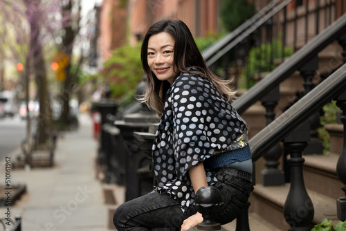 Happy woman outside brownstone  photo