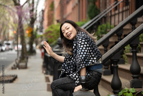 Happy woman waving in neighborhood photo