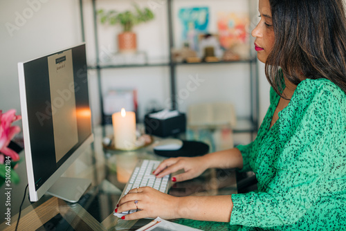 Stylish woman working on desk computer photo