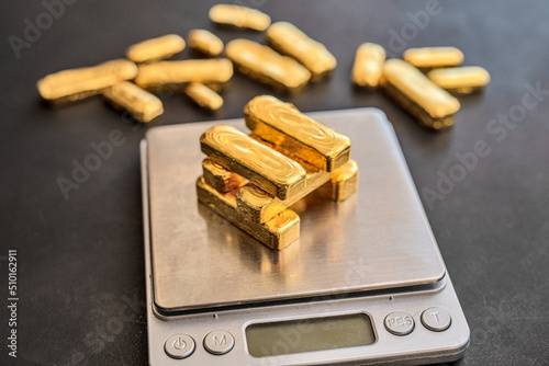 24 carat gold bars on scales photo