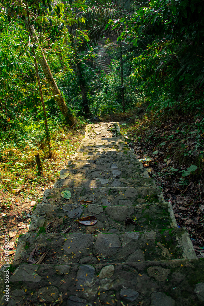 A steep staircase made of cement and stone that sits on a mountain cliff A steep staircase made of cement and stone that sits on a mountain cliff