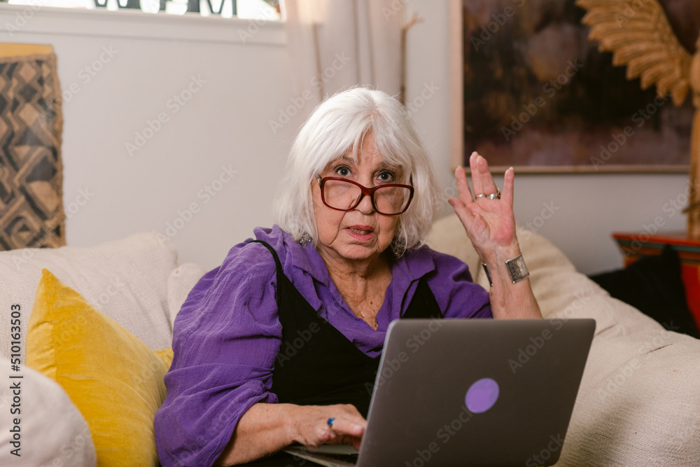 Elderly woman with laptop sitting at home Elderly woman with laptop sitting at home
