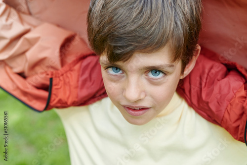 Little boy playing outdoors in a park photo