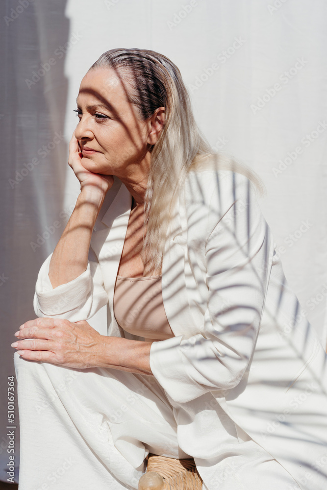 Pensive elegant senior woman relaxing at terrace Pensive elegant senior woman relaxing at terrace