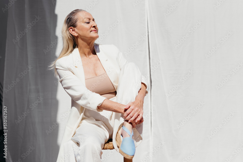 Chic senior woman enjoying the fair weather at terrace