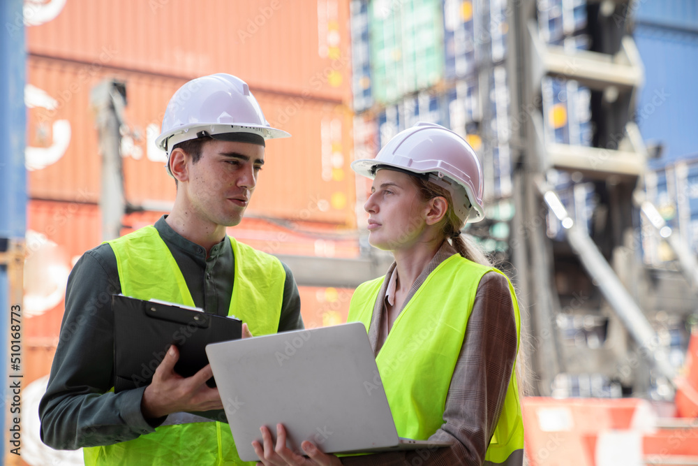 Female Manager technical using laptop to control the global freight through the network. Female Manager technical using laptop to control the global freight through the network.