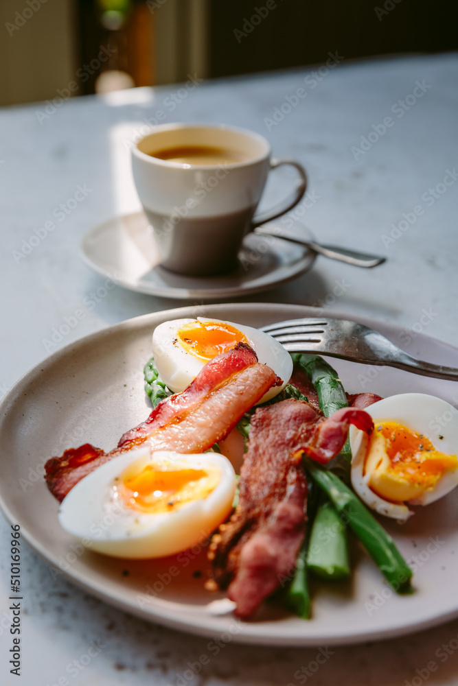 Coffee, bacon, eggs and asparagus