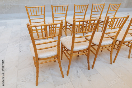 Fancy wooden chairs at a wedding ceremony
