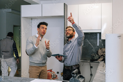 Interior designer discussing kitchen with client photo