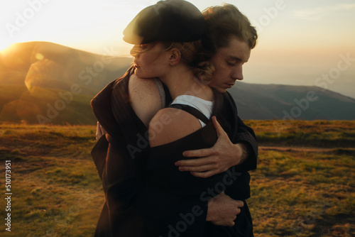 Hugs of lovers among the mountains at sunset