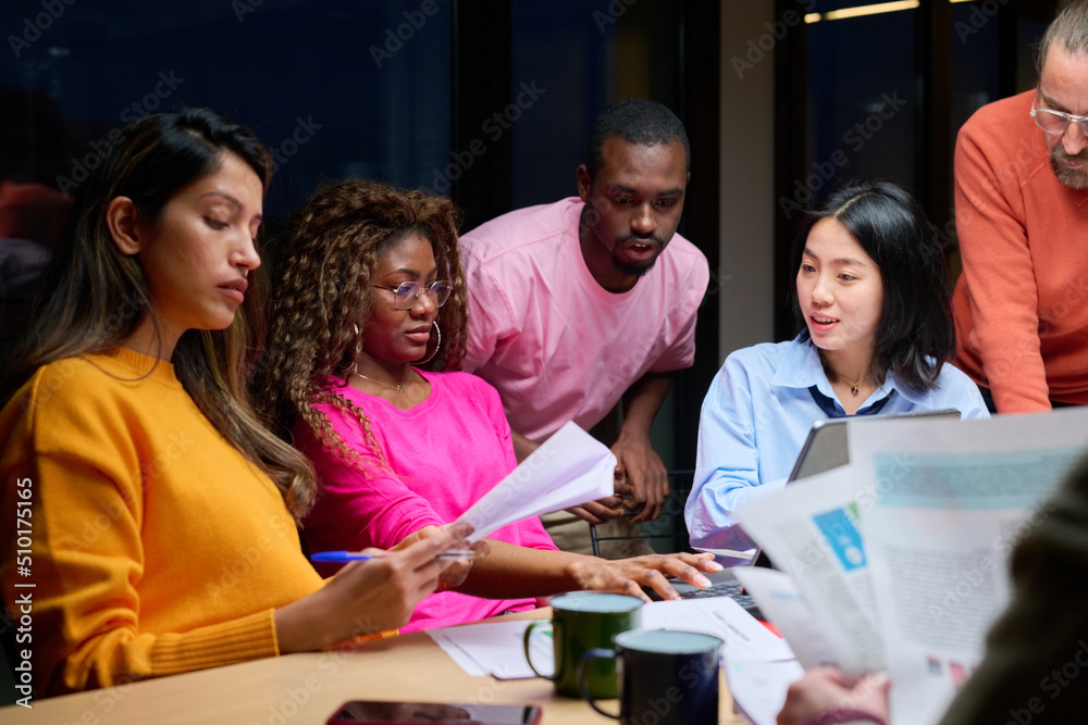 Diverse colleagues brainstorming at night Diverse colleagues brainstorming at night