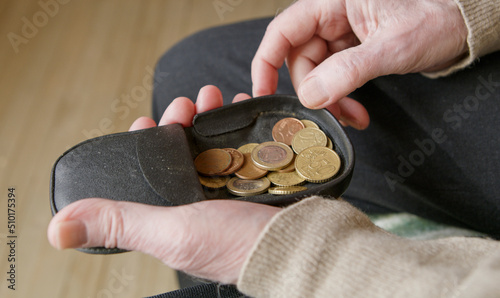 Senior man looking for money in his wallet photo