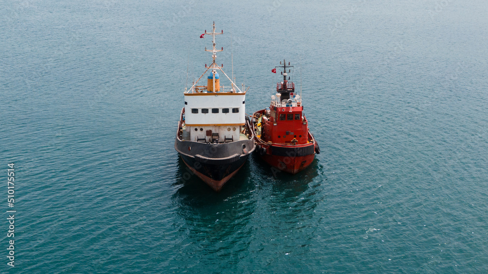 front view of two colourful tugboats moored together, aerial view front view of two colourful tugboats moored together, aerial view