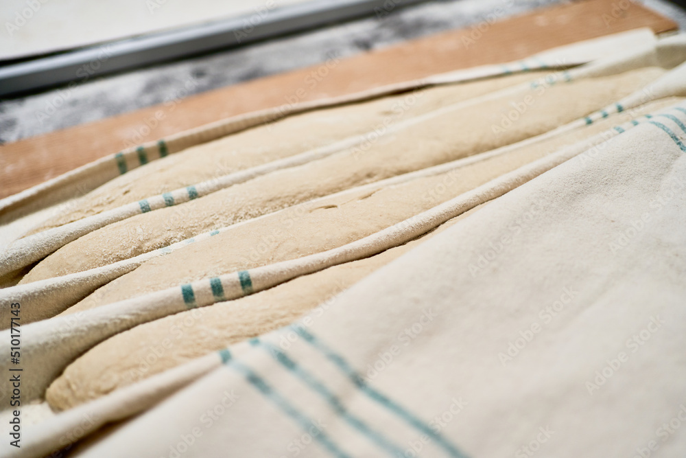 Raw baguettes on tray