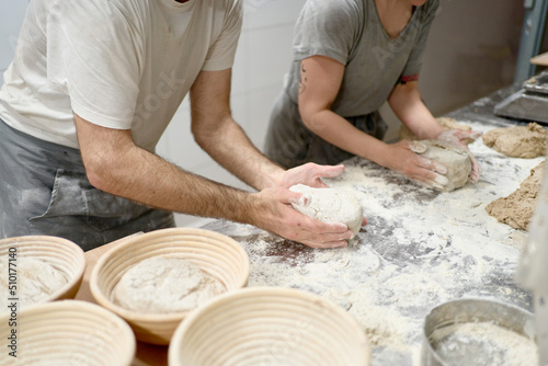 Bakers making bread in bakehouse