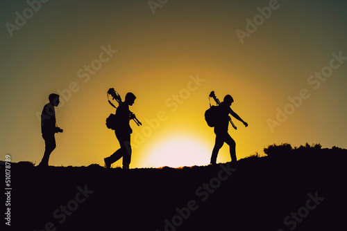 team of photographers walking in nature at morning sunrise time